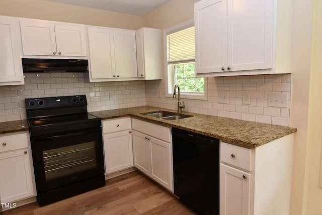 5949 Sandy Run, Knightdale, NC 27545 - kitchen with black appliances, under cabinet range hood, a sink, white cabinets, and light wood-style floors