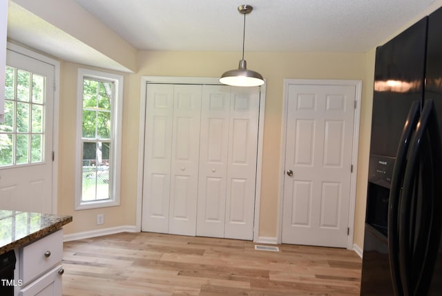 5949 Sandy Run, Knightdale, NC 27545 - unfurnished dining area with light wood-style flooring, plenty of natural light, and baseboards