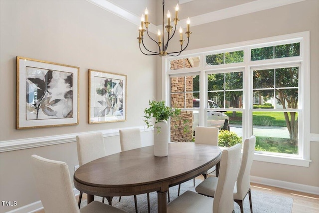 4724 Ludwell Branch Ct, Raleigh, NC 27612 - dining area with a chandelier, baseboards, and light wood finished floors