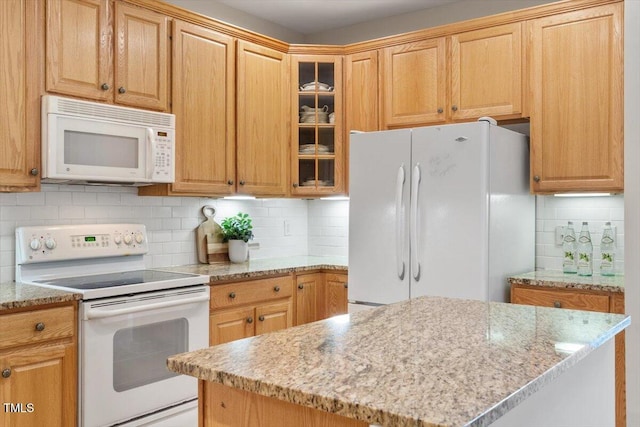 4724 Ludwell Branch Ct, Raleigh, NC 27612 - kitchen featuring white appliances, light stone counters, tasteful backsplash, and glass insert cabinets