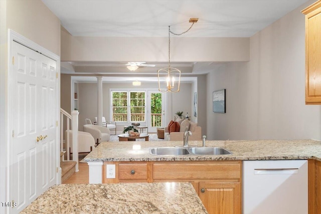 4724 Ludwell Branch Ct, Raleigh, NC 27612 - kitchen with a sink, white dishwasher, light stone countertops, open floor plan, and hanging light fixtures