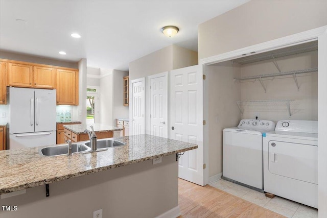 4724 Ludwell Branch Ct, Raleigh, NC 27612 - washroom with washing machine and dryer, recessed lighting, light wood-style floors, and baseboards