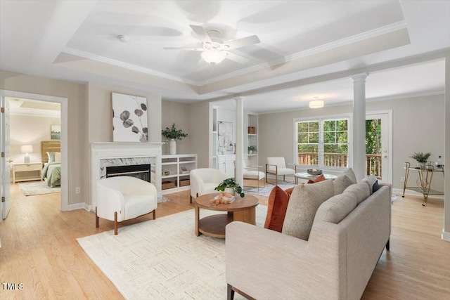 4724 Ludwell Branch Ct, Raleigh, NC 27612 - living room with ornate columns, a tray ceiling, light wood-style floors, and crown molding