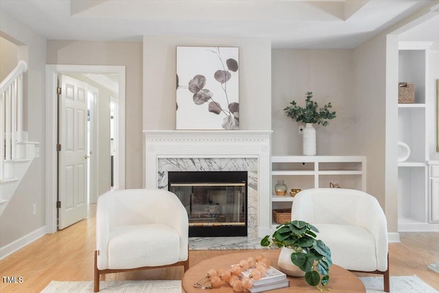 4724 Ludwell Branch Ct, Raleigh, NC 27612 - living room featuring wood finished floors, a premium fireplace, baseboards, and built in shelves