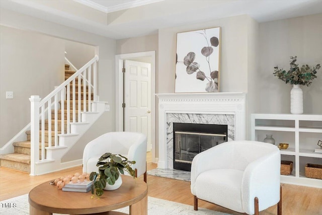 4724 Ludwell Branch Ct, Raleigh, NC 27612 - living room with stairway, wood finished floors, ornamental molding, and a fireplace