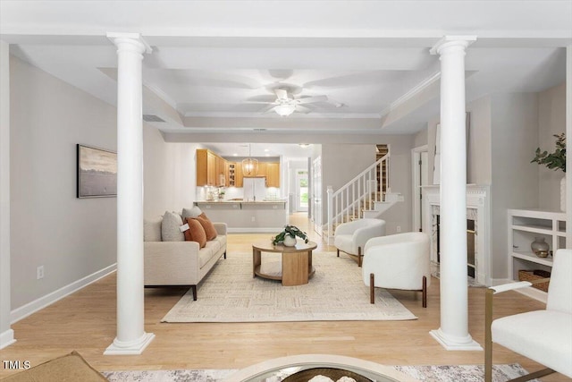 4724 Ludwell Branch Ct, Raleigh, NC 27612 - living room with a ceiling fan, light wood finished floors, crown molding, and ornate columns
