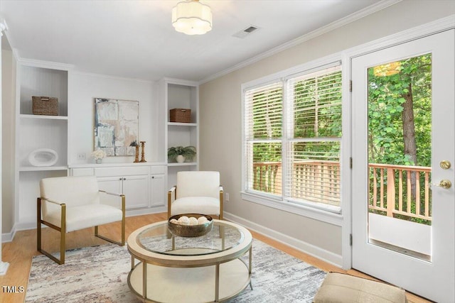 4724 Ludwell Branch Ct, Raleigh, NC 27612 - sitting room featuring light wood finished floors, ornamental molding, plenty of natural light, and built in features
