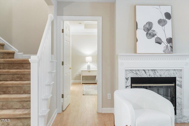 4724 Ludwell Branch Ct, Raleigh, NC 27612 - sitting room featuring stairs, wood finished floors, a high end fireplace, arched walkways, and baseboards