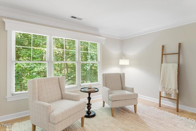 4724 Ludwell Branch Ct, Raleigh, NC 27612 - living area featuring healthy amount of natural light, baseboards, light wood-style floors, and ornamental molding
