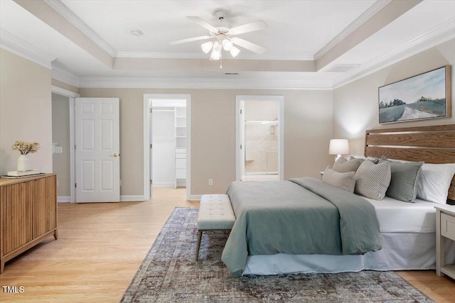 4724 Ludwell Branch Ct, Raleigh, NC 27612 - bedroom featuring a raised ceiling, light wood-type flooring, a spacious closet, ornamental molding, and ensuite bath