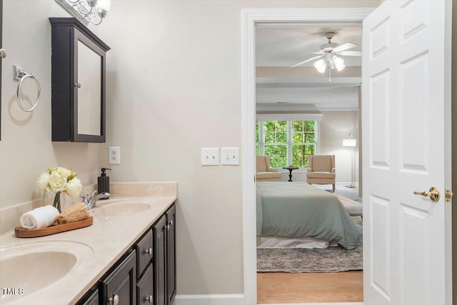 4724 Ludwell Branch Ct, Raleigh, NC 27612 - bathroom with double vanity, connected bathroom, wood finished floors, a ceiling fan, and baseboards