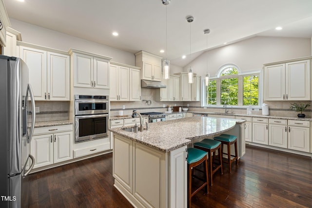 7632 Summer Pines Way, Wake Forest, NC 27587 - kitchen featuring stainless steel appliances, under cabinet range hood, decorative backsplash, a kitchen island with sink, and dark wood-style floors
