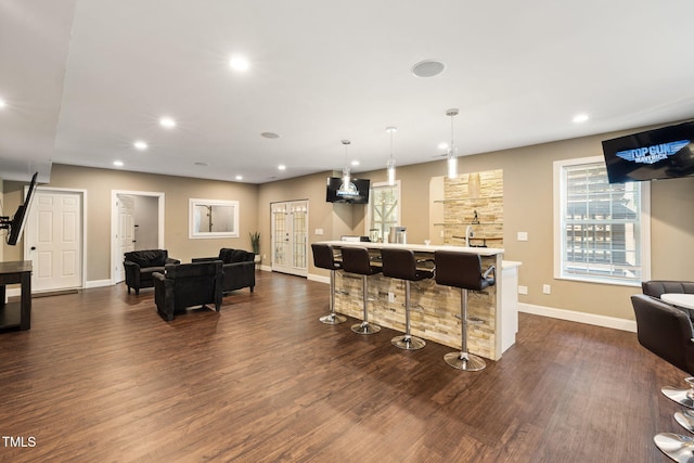 7632 Summer Pines Way, Wake Forest, NC 27587 - kitchen with dark wood finished floors, recessed lighting, open floor plan, a kitchen bar, and light countertops