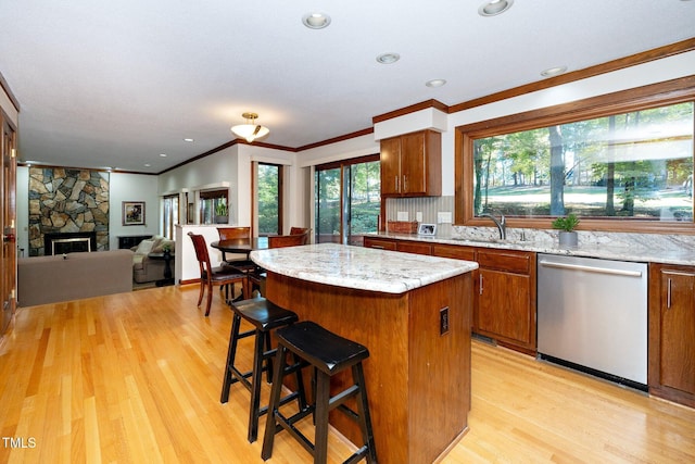 403 Rutherglen Dr, Cary, NC 27511 - kitchen with dishwasher, a sink, ornamental molding, a center island, and light wood-style flooring