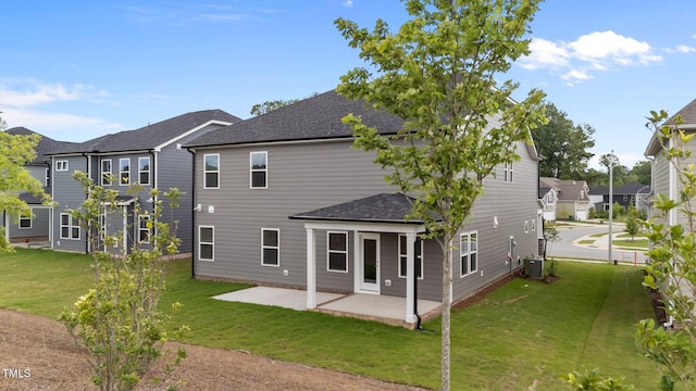 3500 Bailey Lake Dr, Fuquay Varina, NC 27526 - back of house featuring a shingled roof, a patio area, a yard, and a residential view