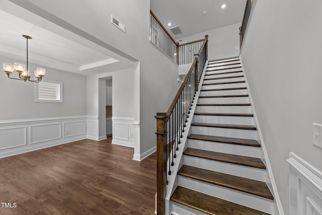 3500 Bailey Lake Dr, Fuquay Varina, NC 27526 - staircase featuring a chandelier, wood finished floors, and a wainscoted wall