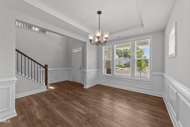 3500 Bailey Lake Dr, Fuquay Varina, NC 27526 - unfurnished dining area featuring a chandelier, dark wood-type flooring, a wainscoted wall, stairs, and a decorative wall