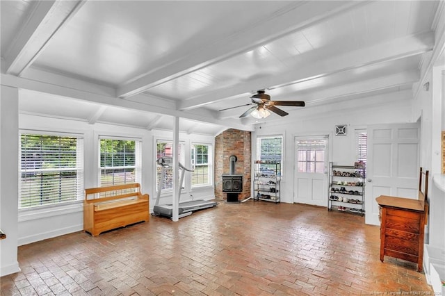 239 Rainier Dr, Fayetteville, NC 28314 - living room featuring a wood stove, brick flooring, a ceiling fan, beamed ceiling, and baseboards