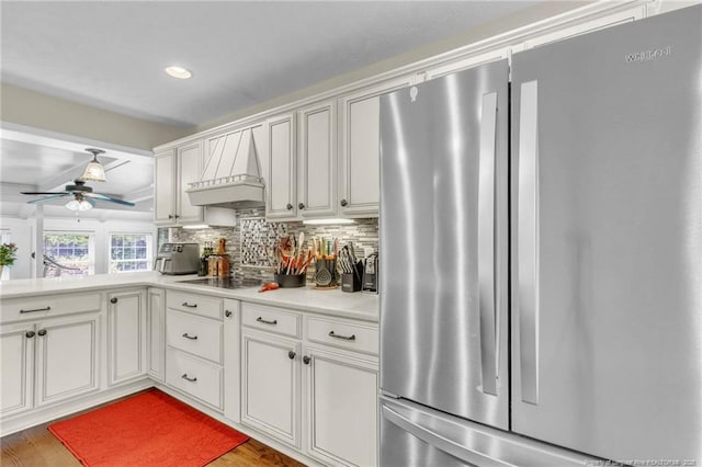 239 Rainier Dr, Fayetteville, NC 28314 - kitchen with freestanding refrigerator, tasteful backsplash, light countertops, ceiling fan, and white cabinets
