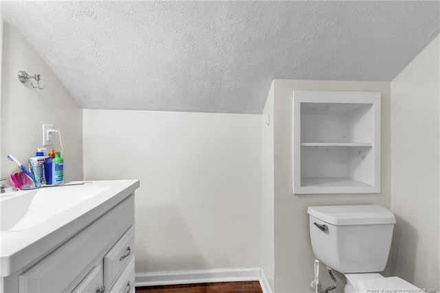 239 Rainier Dr, Fayetteville, NC 28314 - half bathroom with a textured ceiling, vanity, toilet, and lofted ceiling