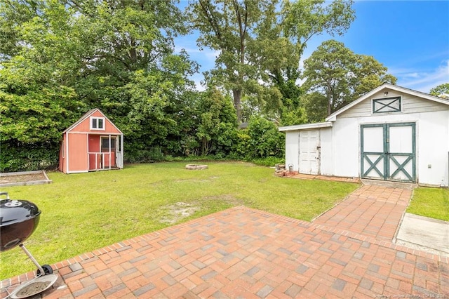 239 Rainier Dr, Fayetteville, NC 28314 - view of grassy yard with an outdoor fire pit