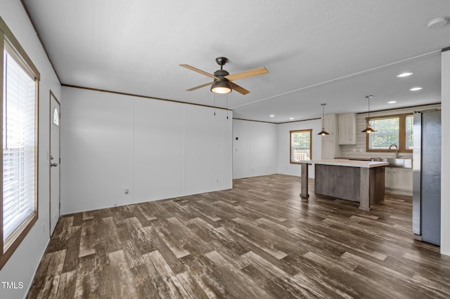 130 Ruby Trl, Roxboro, NC 27574 - unfurnished living room with dark wood-style floors, ceiling fan, and recessed lighting