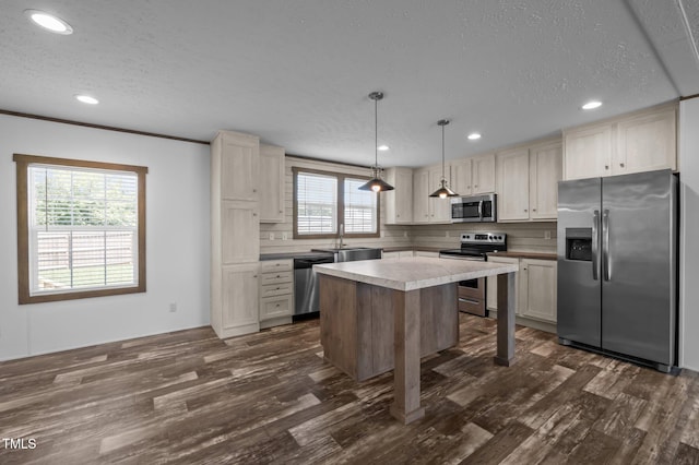 130 Ruby Trl, Roxboro, NC 27574 - kitchen featuring appliances with stainless steel finishes, a textured ceiling, dark wood finished floors, a kitchen island, and recessed lighting