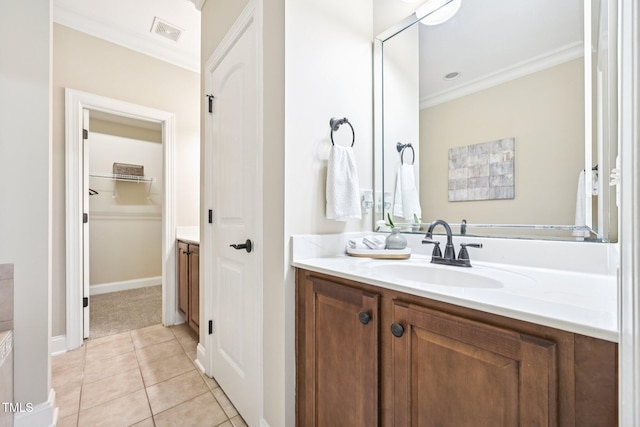 1090 Indigo Ridge Pl, Cary, NC 27519 - bathroom featuring vanity, ornamental molding, tile patterned floors, and a spacious closet