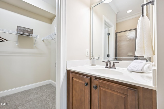 1090 Indigo Ridge Pl, Cary, NC 27519 - bathroom with vanity, an enclosed shower, a spacious closet, and ornamental molding