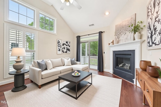 1090 Indigo Ridge Pl, Cary, NC 27519 - living area featuring high vaulted ceiling, dark wood-style floors, ceiling fan, a glass covered fireplace, and recessed lighting