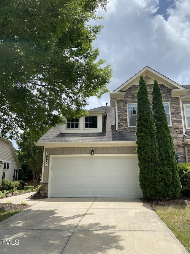 1090 Indigo Ridge Pl, Cary, NC 27519 - view of front of property featuring stone siding, driveway, and a garage