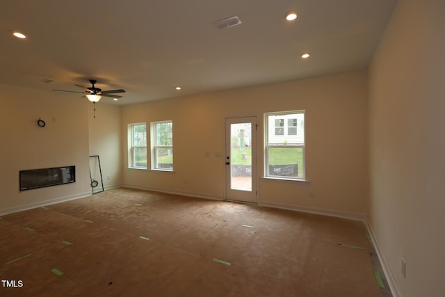 6973 Doddridge Ln Unit 17, Cary, NC 27519 - unfurnished living room with recessed lighting, a ceiling fan, baseboards, and a glass covered fireplace