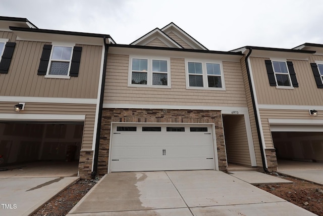 6973 Doddridge Ln Unit 17, Cary, NC 27519 - view of front of property with stone siding, driveway, and an attached garage