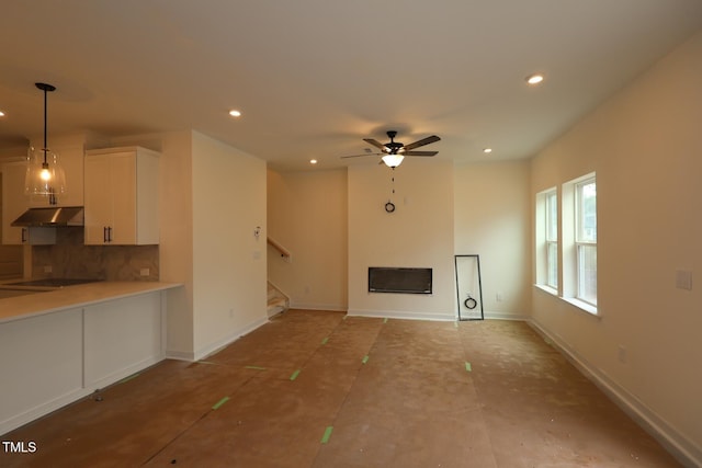 6973 Doddridge Ln Unit 17, Cary, NC 27519 - unfurnished living room with recessed lighting, a fireplace, baseboards, stairway, and a ceiling fan