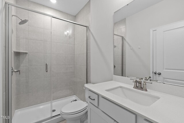 309 Highland Forest Dr, Fuquay Varina, NC 27526 - bathroom with vanity, a stall shower, and toilet