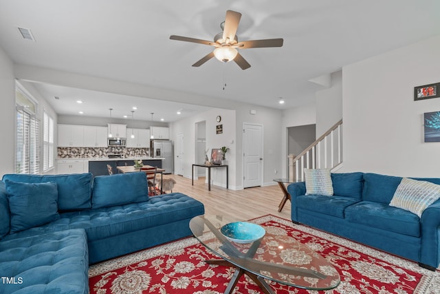 309 Highland Forest Dr, Fuquay Varina, NC 27526 - living area with stairway, ceiling fan, light wood finished floors, and recessed lighting