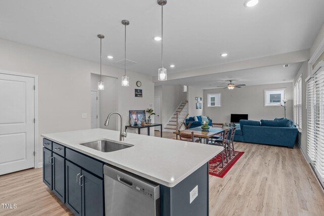309 Highland Forest Dr, Fuquay Varina, NC 27526 - kitchen with dishwasher, a sink, open floor plan, light wood-style floors, and light countertops