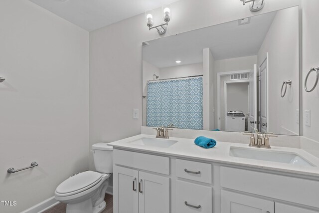 309 Highland Forest Dr, Fuquay Varina, NC 27526 - full bathroom featuring double vanity, toilet, washer / clothes dryer, and a shower with shower curtain