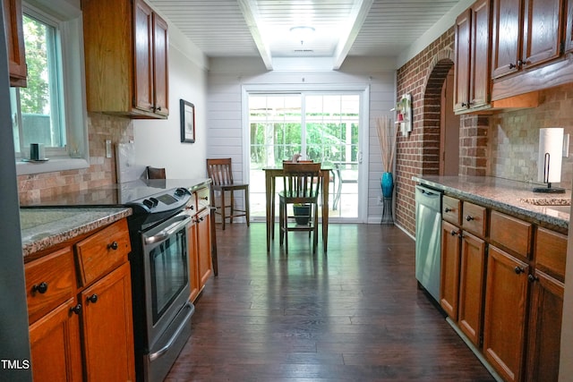 1423 Alderman Cir, Raleigh, NC 27603 - kitchen featuring stainless steel appliances, beamed ceiling, dark wood-style floors, tasteful backsplash, and brown cabinets