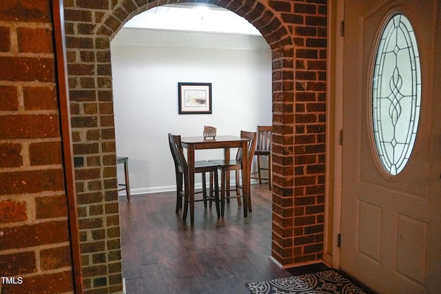 1423 Alderman Cir, Raleigh, NC 27603 - foyer entrance featuring arched walkways, dark wood-style floors, and baseboards