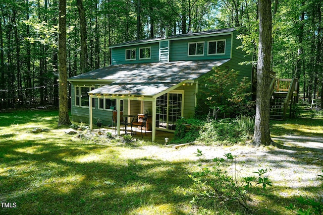 1423 Alderman Cir, Raleigh, NC 27603 - rear view of property with a shingled roof, a patio area, a lawn, and stairway