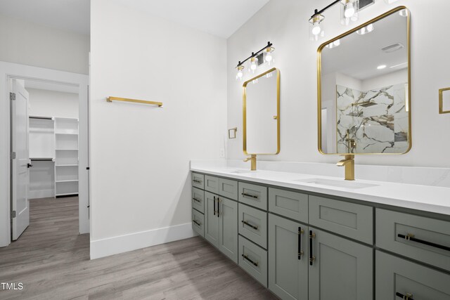 107 Mohave Dr, Louisburg, NC 27549 - bathroom with double vanity, wood finished floors, a marble finish shower, a spacious closet, and baseboards