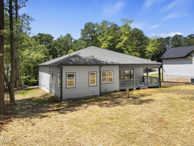 107 Mohave Dr, Louisburg, NC 27549 - back of property featuring roof with shingles and a lawn
