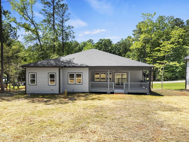 107 Mohave Dr, Louisburg, NC 27549 - rear view of property with roof with shingles, a yard, and a wooden deck