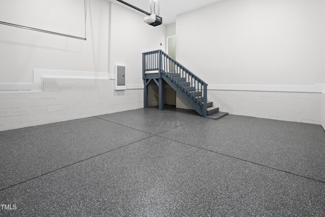 107 Mohave Dr, Louisburg, NC 27549 - garage featuring concrete block wall, a garage door opener, and electric panel