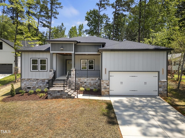 107 Mohave Dr, Louisburg, NC 27549 - view of front facade featuring stone siding, a porch, an attached garage, and roof with shingles