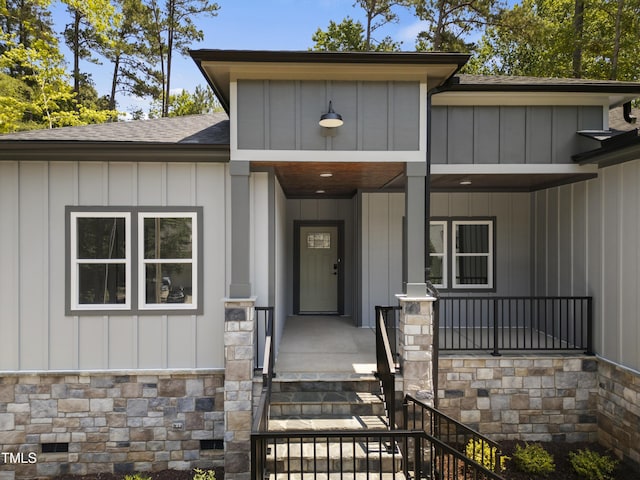 107 Mohave Dr, Louisburg, NC 27549 - entrance to property featuring a shingled roof, stone siding, and board and batten siding