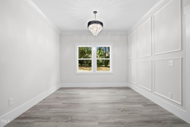107 Mohave Dr, Louisburg, NC 27549 - unfurnished dining area with a chandelier, crown molding, light wood finished floors, and baseboards