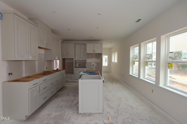 7106 Hubner Pl Unit 44, Cary, NC 27519 - kitchen with a kitchen island and baseboards