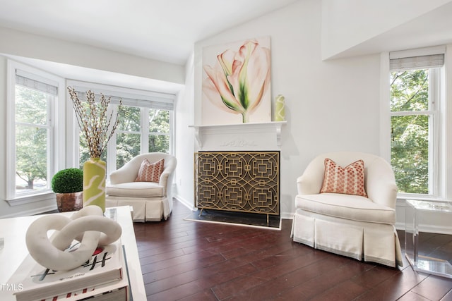 911 Washington St Unit 304, Raleigh, NC 27605 - sitting room with wood finished floors, baseboards, a fireplace with raised hearth, and lofted ceiling
